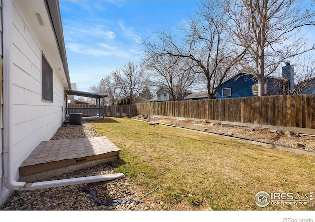 view of yard featuring central AC and a fenced backyard