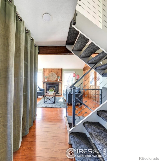 stairway featuring a fireplace and hardwood / wood-style flooring