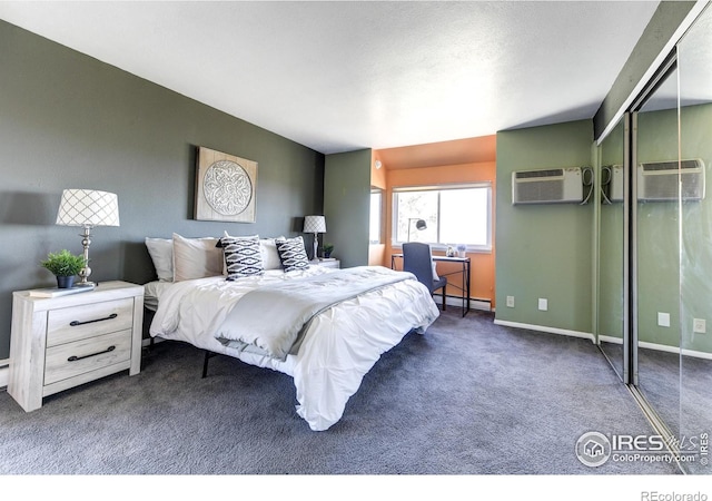 bedroom with baseboards, an AC wall unit, baseboard heating, carpet flooring, and a closet