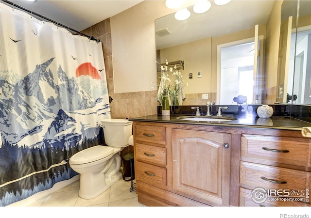 full bathroom featuring tile patterned floors, visible vents, toilet, tile walls, and vanity