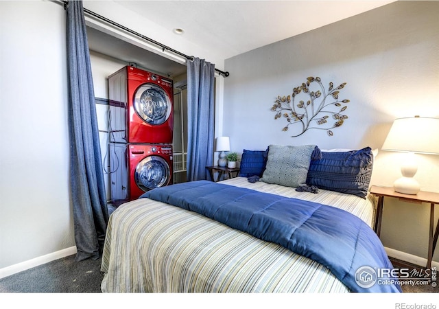 bedroom with stacked washer / dryer, baseboards, and carpet floors