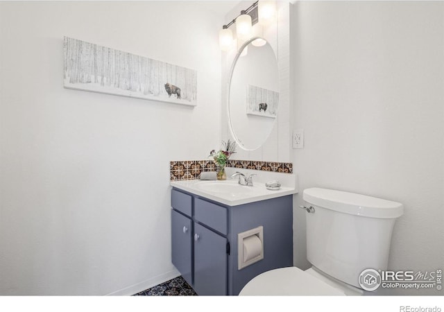 half bathroom with toilet and vanity