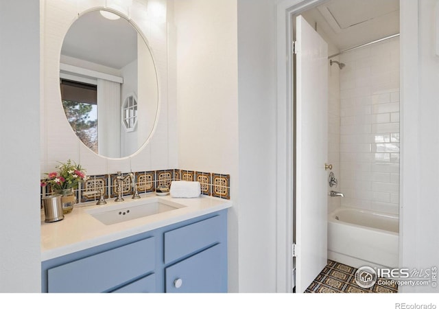 bathroom with backsplash, vanity, and bathing tub / shower combination