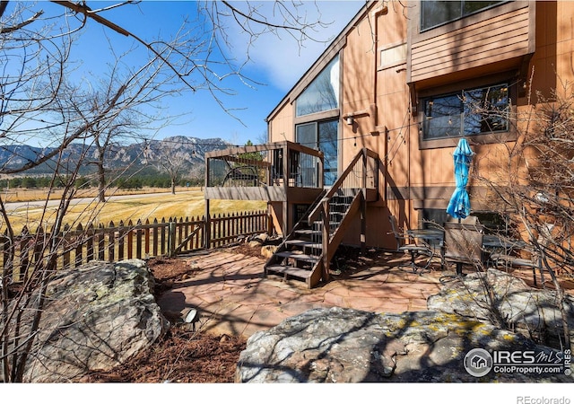 exterior space featuring stairway, fence, and a mountain view