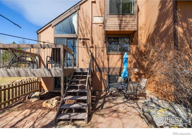 view of patio with stairway and outdoor dining space