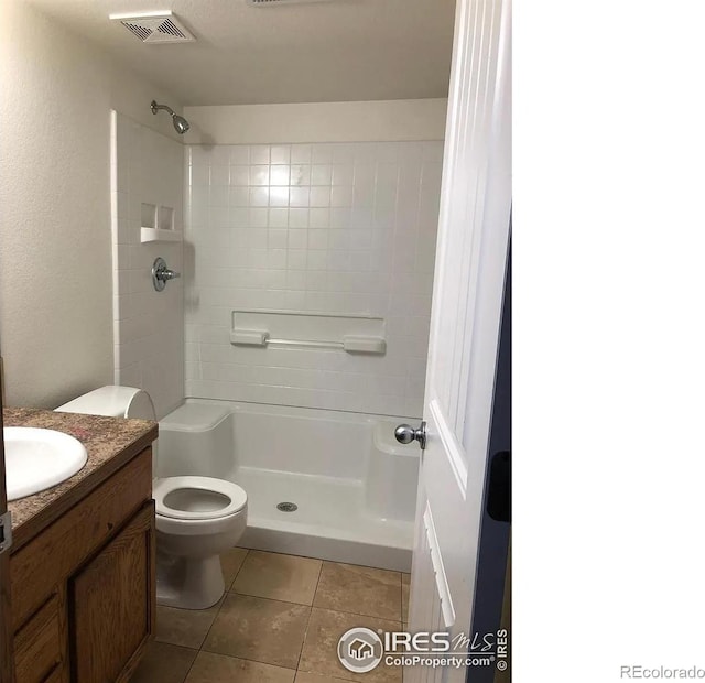 bathroom with tile patterned floors, visible vents, toilet, a shower, and vanity