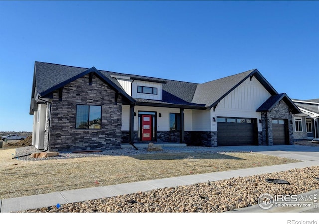 view of front of home featuring stone siding, roof with shingles, board and batten siding, concrete driveway, and an attached garage