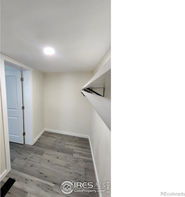 walk in closet with wood finished floors and visible vents
