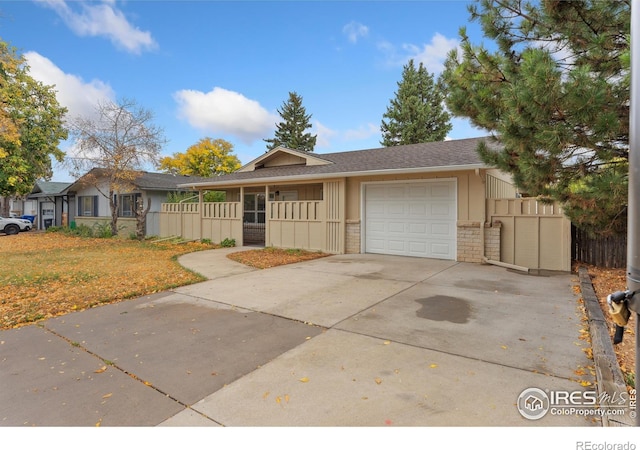 single story home featuring brick siding, concrete driveway, and a garage