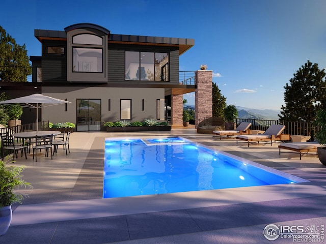 view of pool with a fenced in pool, a fireplace, a patio, and fence