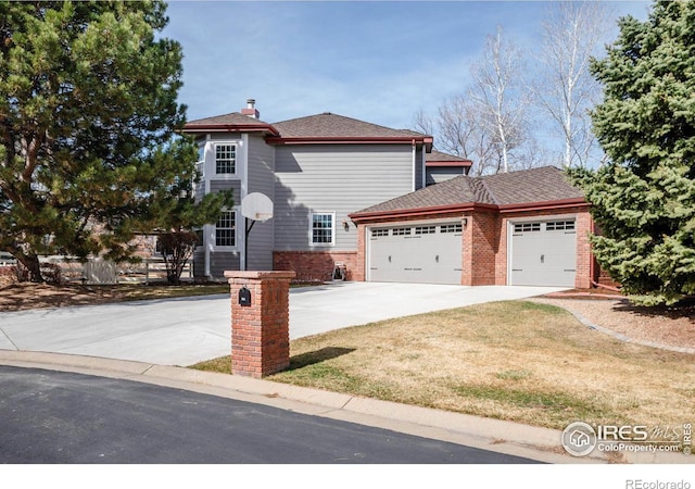 view of front of house featuring a front yard, concrete driveway, a garage, and a shingled roof