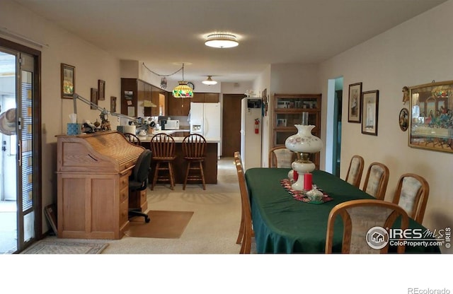 dining area with light colored carpet