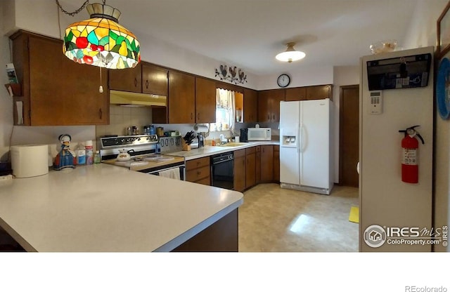 kitchen with white appliances, light floors, a sink, light countertops, and under cabinet range hood