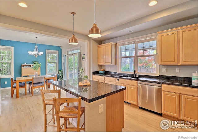 kitchen with a sink, dishwasher, light brown cabinets, and light wood finished floors