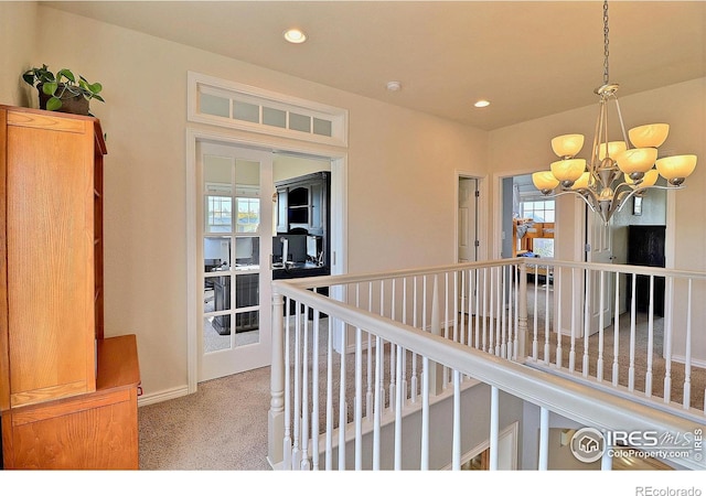 corridor featuring an upstairs landing, recessed lighting, carpet, an inviting chandelier, and baseboards