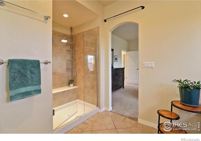 full bath with baseboards, a shower stall, and tile patterned flooring