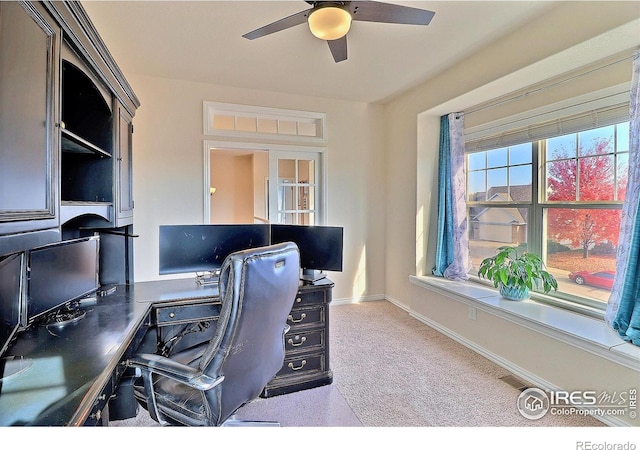 home office with carpet flooring, a ceiling fan, and baseboards