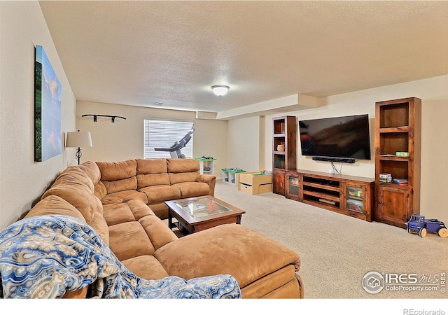 living area with carpet flooring, visible vents, and a textured ceiling