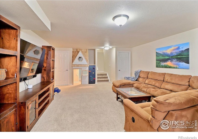 carpeted living area featuring stairs and a textured ceiling