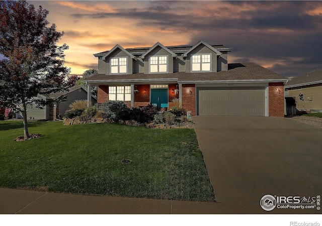 view of front of home with solar panels, concrete driveway, a yard, and brick siding