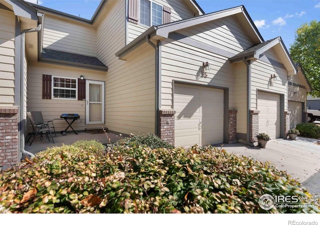 view of property exterior featuring brick siding and driveway