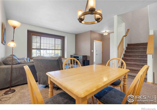 dining area featuring stairway, carpet floors, and a notable chandelier