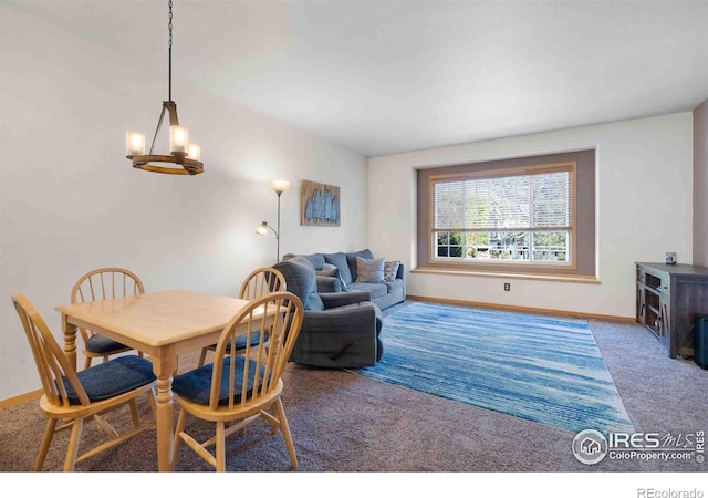 carpeted dining area featuring a chandelier and baseboards