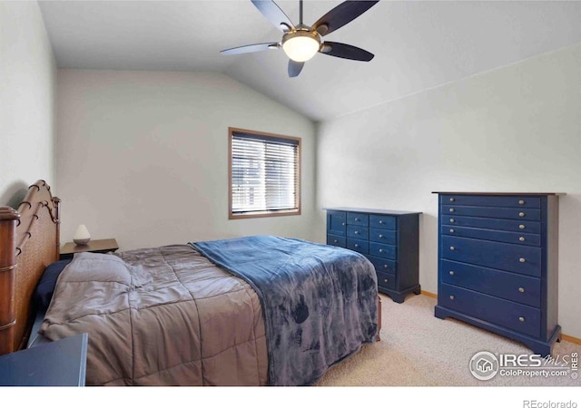 bedroom featuring vaulted ceiling, light colored carpet, and ceiling fan