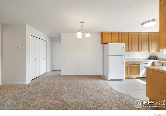 kitchen with white appliances, light tile patterned floors, light countertops, a notable chandelier, and light colored carpet