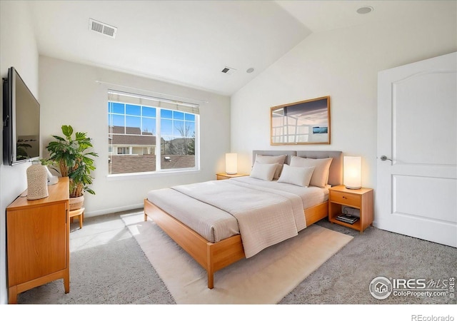 bedroom with visible vents, carpet, and lofted ceiling