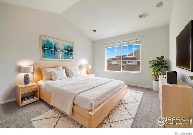 bedroom with visible vents, baseboards, light colored carpet, and vaulted ceiling