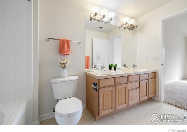 full bathroom with a sink, baseboards, toilet, and double vanity