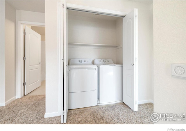 laundry area featuring laundry area, washing machine and dryer, baseboards, and carpet floors