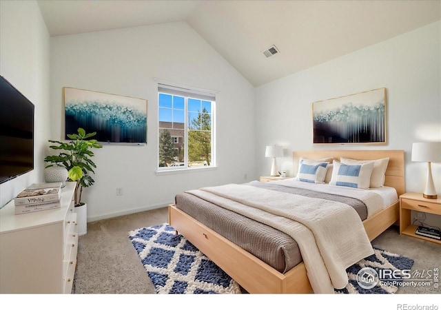 bedroom with lofted ceiling, baseboards, visible vents, and carpet floors