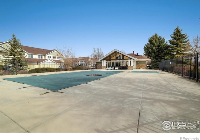 pool featuring a patio area and fence