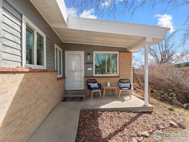 entrance to property featuring brick siding