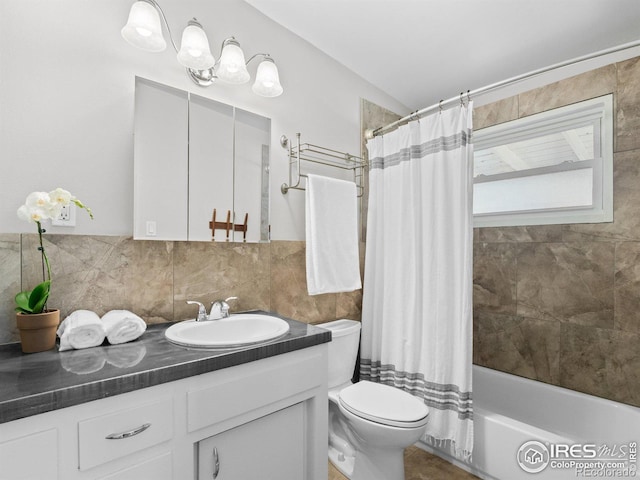 bathroom with vanity, shower / bath combination with curtain, tile walls, toilet, and tasteful backsplash