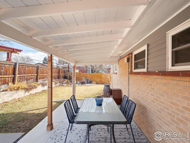 view of patio with outdoor dining space and a fenced backyard