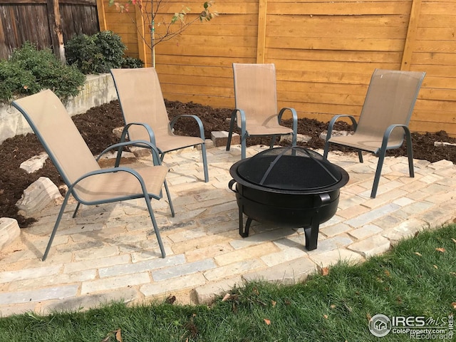 view of patio with fence and an outdoor fire pit