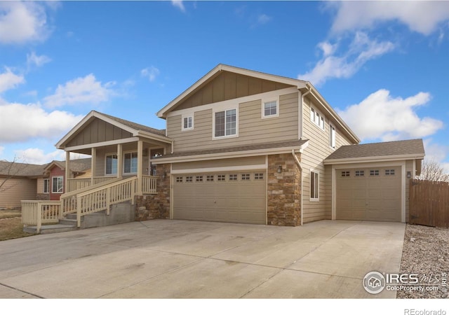 view of front of house featuring stone siding, board and batten siding, concrete driveway, and an attached garage