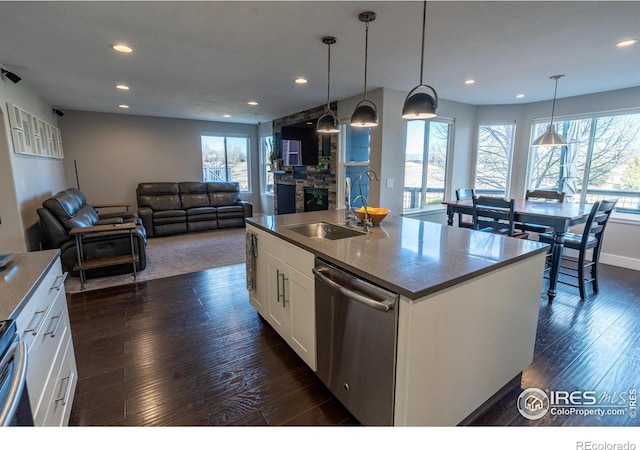 kitchen featuring dark wood-type flooring, recessed lighting, stainless steel dishwasher, white cabinetry, and a sink