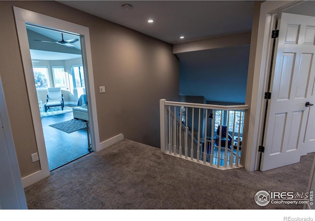 corridor featuring recessed lighting, an upstairs landing, baseboards, and carpet floors