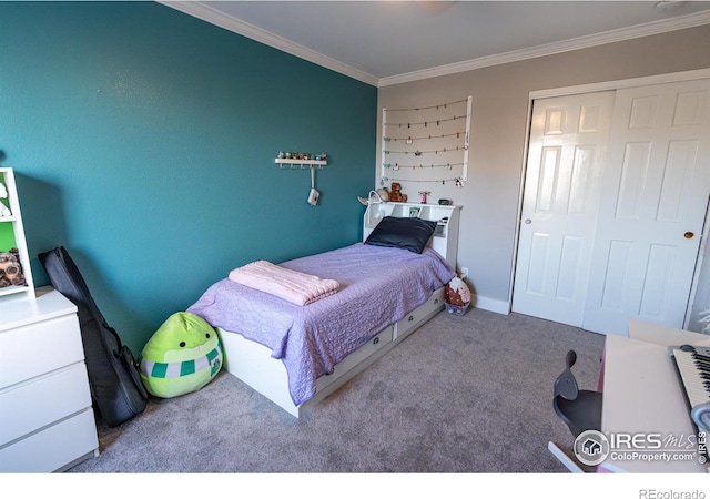 carpeted bedroom with a closet and crown molding