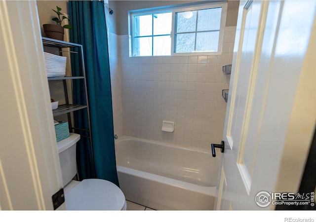 bathroom featuring toilet and shower / bathtub combination with curtain