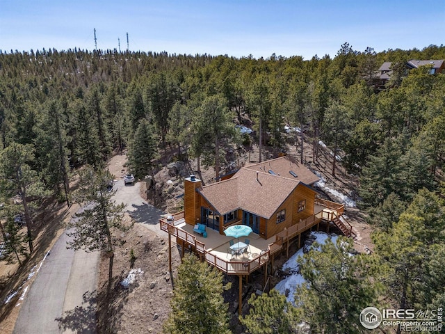 drone / aerial view featuring a forest view