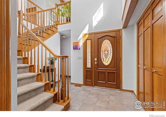 82 Grove Ct, Boulder, CO 80302 - entryway featuring baseboards, stairs, and a high ceiling