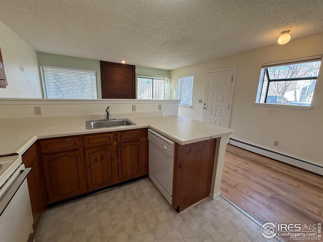 kitchen with light floors, white dishwasher, electric range oven, a sink, and light countertops