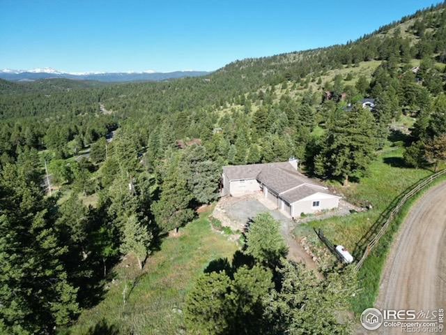 bird's eye view with a mountain view and a view of trees