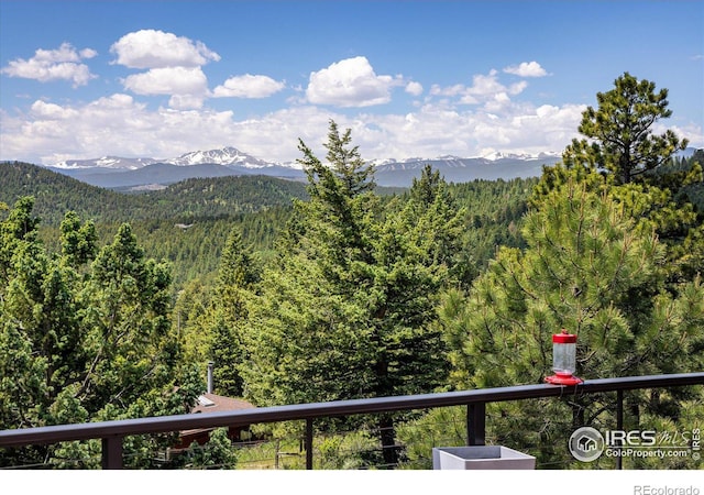 view of mountain feature with a forest view