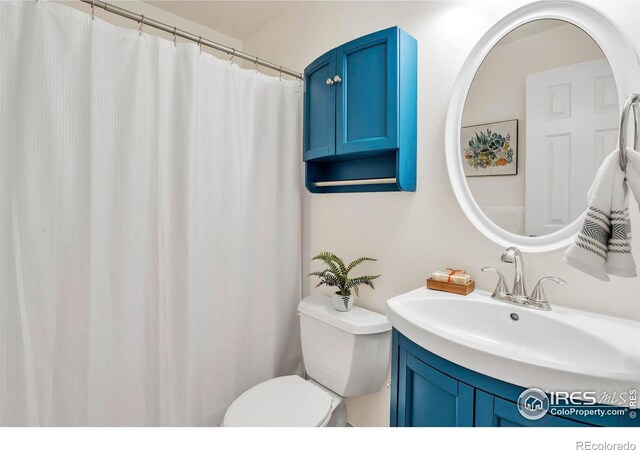 full bathroom with toilet and vanity